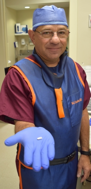 M. Wail Hashimi, M.D., FACC is pictured here, holding the MitraClip.